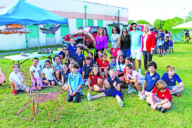 Village artist donates dolphin sculpture to Coral Reef Elem