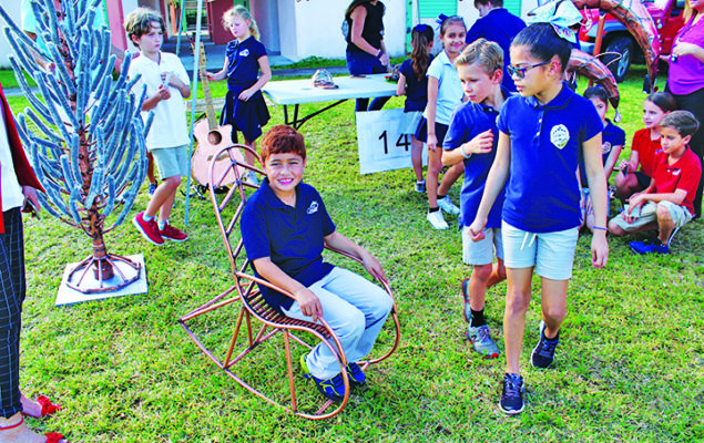 Village artist donates dolphin sculpture to Coral Reef Elem