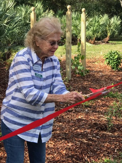 East Ridge resident Nancy Fehr cuts the ceremonial ribbon.