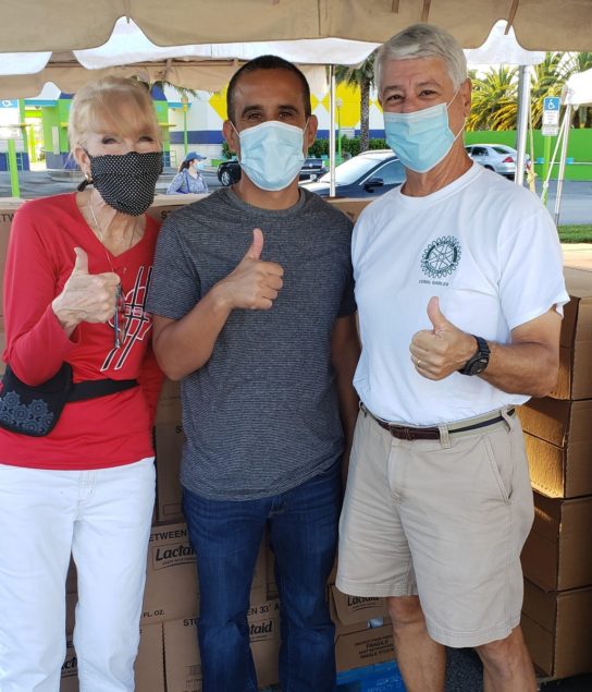 Volunteering at Feeding South Florida's food distribution event are CGWC member and RCCG Civic and Charity chair Gloria Burns; Rise Against Hunger's Gilbert Chaidez, and RCCG past president Walter Alvarez.