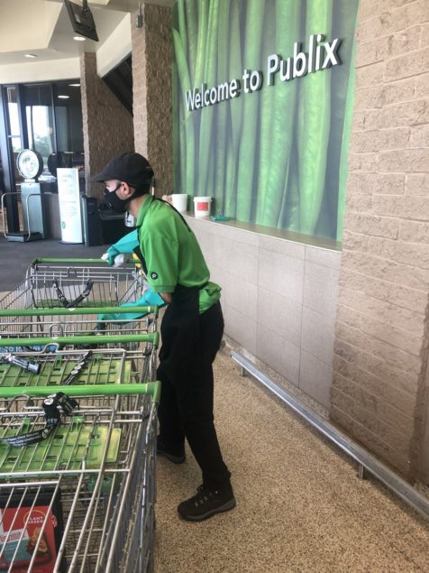 Guillermo Acosta rounds up carts at Publix Supermarket #223 on S. Dixie Highway.