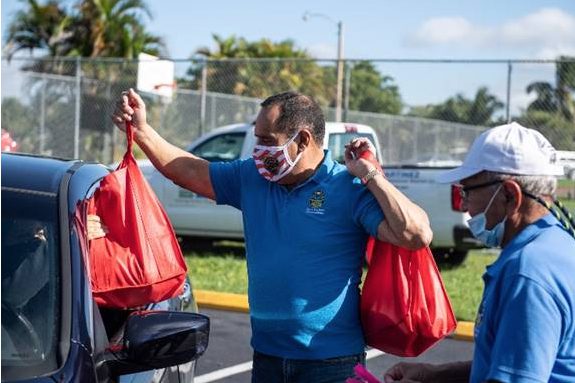 Commissioner Martinez distributes free turkeys to residents in need