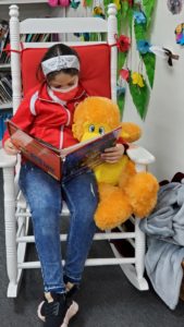 Gabriella Saravia is pictured here with her reading buddy.