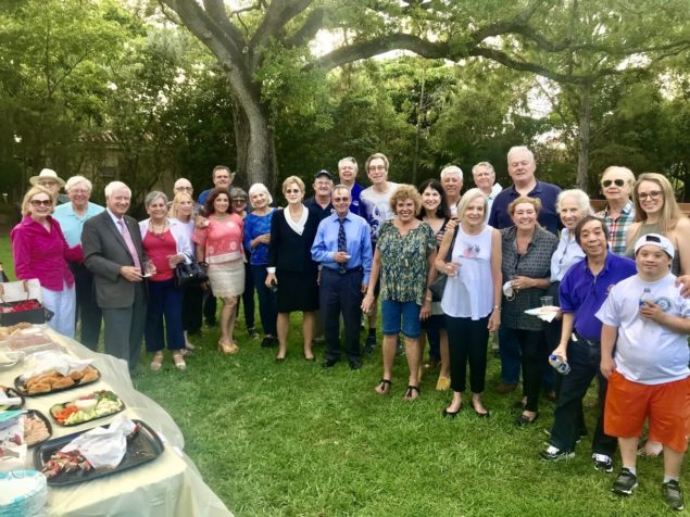 Members and guests of the Rotary Club of Coral Gables are pictured  enjoying an early evening social at Rotary Centennial Park.