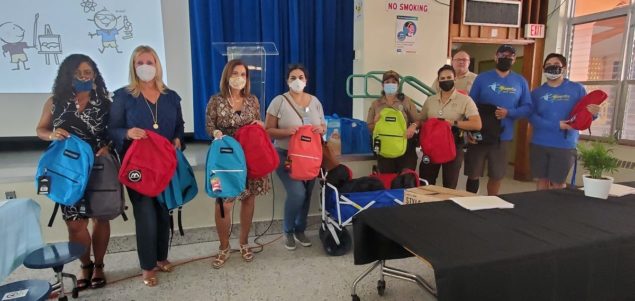 Village and Ocaquatics join to donate backpacks