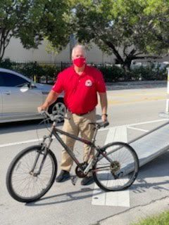 ORNA Security and Biscayne Cove ‘rain sunshine’ over North Miami Beach Sr. High with bike donation