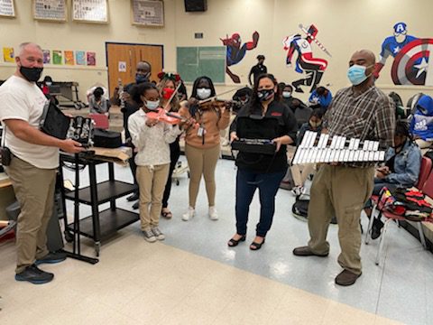 Orna Security donates instruments to North Miami Beach Sr. High School By Elaine Adler Members of the Aventura Marketing Council/Chamber of Commerce have long been hearing about the many needs of students enrolled at North Miami Beach Senior High School.  The school has a  Community Store where not only the students and their families can select clothing, household goods and even furniture free of charge, but so can the entire community.  It’s a great feeling to know that whatever you donate will be so appreciated and so needed! Belina Nagar, Founder of ORNA Security in Aventura, had already partnered with Biscayne Cove Condo Association to donate clothing and furniture to the NMB Community Store.   When Nagar found out that the school had basically no music programs because they couldn’t afford to buy instruments, she decided to do something about it. She found a source for good used instruments, purchased them and recently presented them to the school with Principal Randy Milliken, Special Education Teacher Veronica Martin and Band Teacher James Lockhart. Martin said, “ In a time when instructional music programs are shrinking or closing down due to budget constraints, the Music Department at North Miami Beach never expected to receive a donation of six clarinets, a flute, four violins, a keyboard and a 32- key xylophone.  This generous donation came from Belina Garazi owner of Orna Security, after she heard that not all the music students at NMB can afford to rent or buy an instrument and the school inventory is badly worn or nonexistent.   Many of these students have had few opportunities to experience live music--they learn about music history and the sound a particular musical instrument should make.  For years,  many of our students have not had tangible instrument experience.  During past performances, they have had to share instruments due to economic hardship.  Ms. Garazi made a commitment to help enrich and support our music program.   On behalf of the students and staff of North Miami Beach Senior we want to express our heartfelt appreciation to Belina Garazi for her support.  We are very grateful for the musical instruments donation and the opportunity to continue the music program for our young people.  We also want to thank Aron Adler for finding these instruments—all of them in great working order--  and the Aventura Marketing Council/Chamber of Commerce for organizing this community effort.”  North Miami Beach Senior High School is located at 1247 NE 167th Street, North Miami Beach 33162. 305.949.8381    