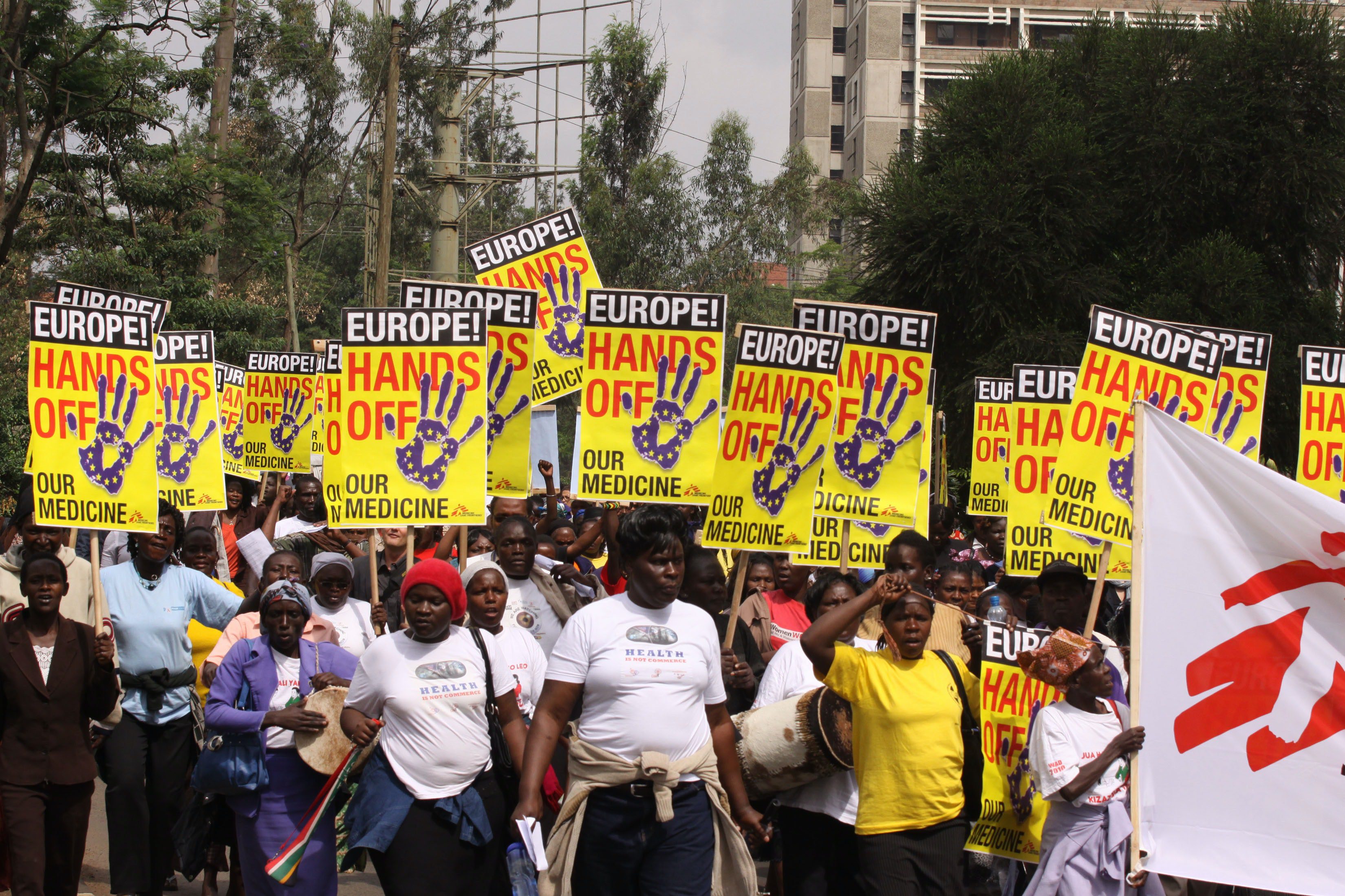 Activists marching with signs reading 'Europe! Hands off our medicine'