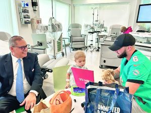 Dolphins, UM Football join forces with AutoNation DRV PNK to deliver hope to cancer patients