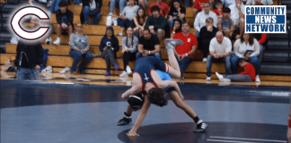 Grant Miller joins in the fun and watch and salutes wrestling Coach Jacob Grant of Columbus his first dual meet Palmetto High at Christopher Columbus