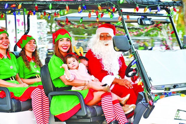 Holiday Golf Cart Parade lights up town’s streets