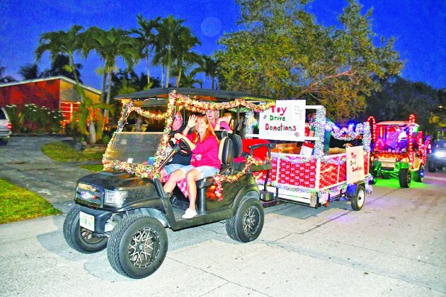 Holiday Golf Cart Parade lights up town’s streets