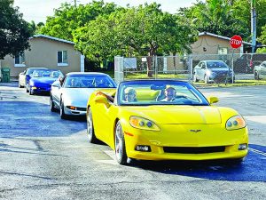 Sunshine Corvette Club brings holiday cheer, gifts to local students