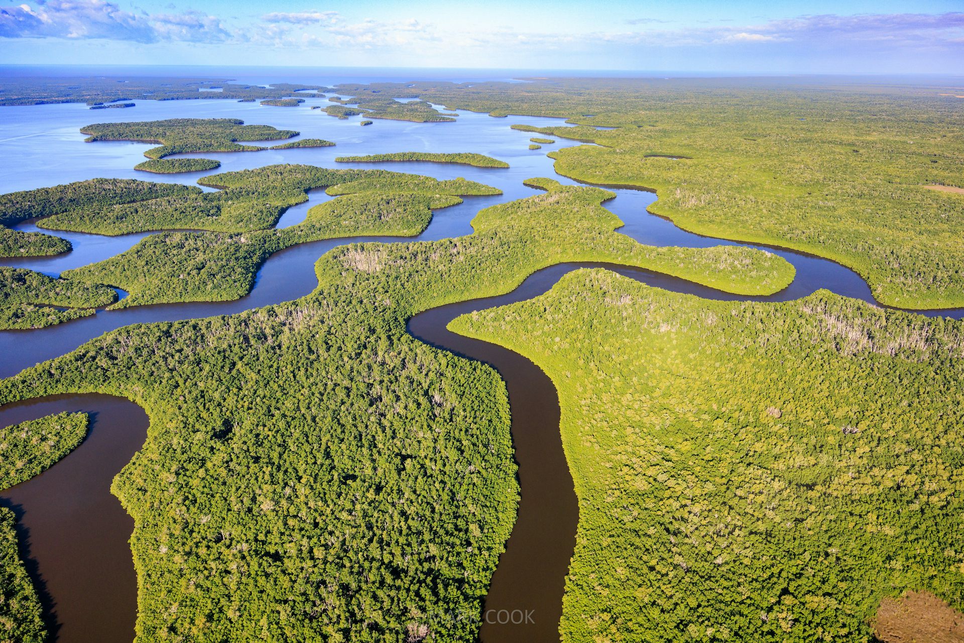 An aerial view with waterways and an area of open water in the Everglades.