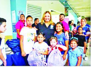 Colucci, Rosado distribute backpacks, school supplies
