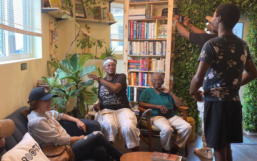 Roots acts as a community space and venue. Co-owner Cameron Agnew greets guests who arrived for the "Good Trouble Lives On" protest on July 17.