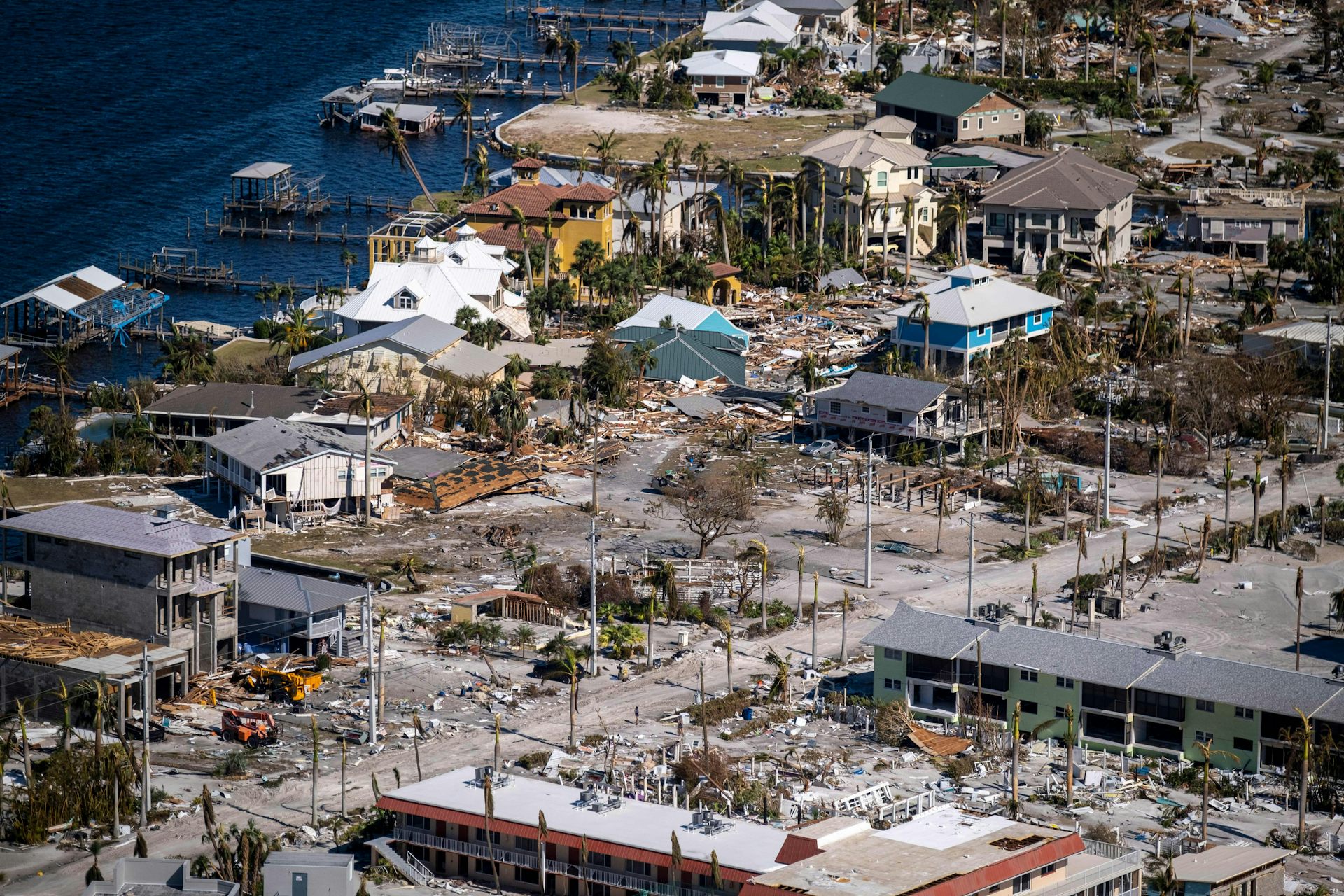 A coastal area with severe damage to homes and others buildings.