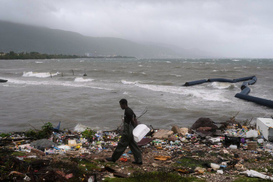 A man walks along the coastline during the passing of Hurricane Melissa in Kingston, Jamaica, Tuesday, Oct. 28, 2025.