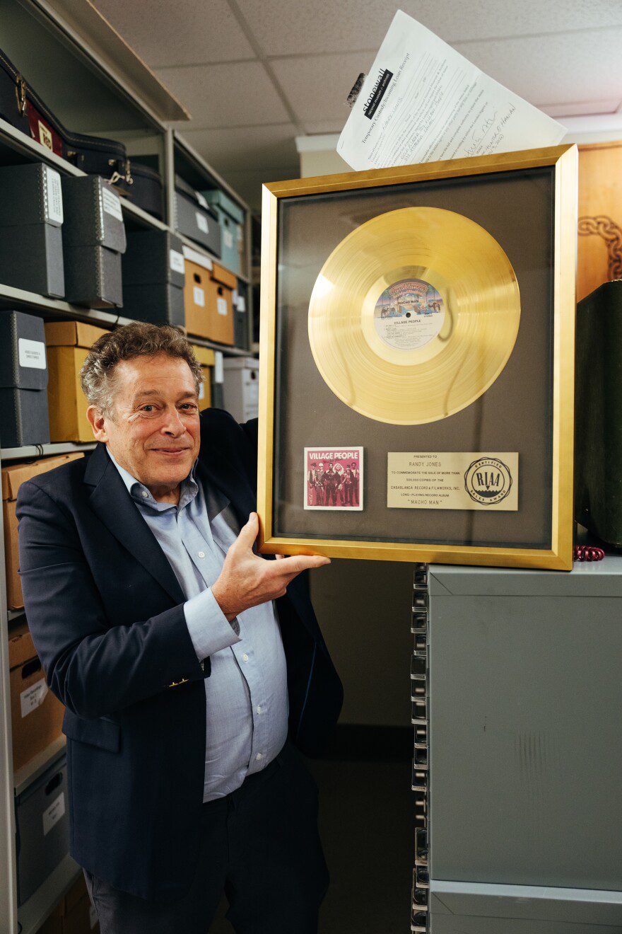 Robert Kesten, president of the Stonewall National Museum, Archives and Library, shows a gold record awarded to the Village People for their 1978 hit “Macho Man,” at the institution in Fort Lauderdale, Fla., Sept. 8, 2025. The museum, one of the country’s oldest LGBTQ institutions, is facing deep cuts and may need a new home.