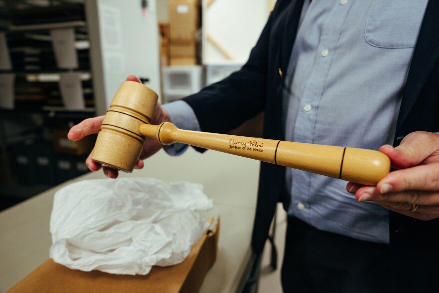 Robert Kesten, president of the Stonewall National Museum, Archives and Library, shows a gavel, inscribed with the signature of former Speaker of the House Nancy Pelosi, that was used in Congress when the U.S. military’s “Don’t Ask, Don’t Tell” policy was repealed, at the institution in Fort Lauderdale, Fla., Sept. 8, 2025. The museum, one of the country’s oldest LGBTQ institutions, is facing deep cuts and may need a new home.